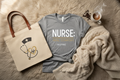Compassion & Coffee nurse bundle flat lay with tee, tote bag, and blanket